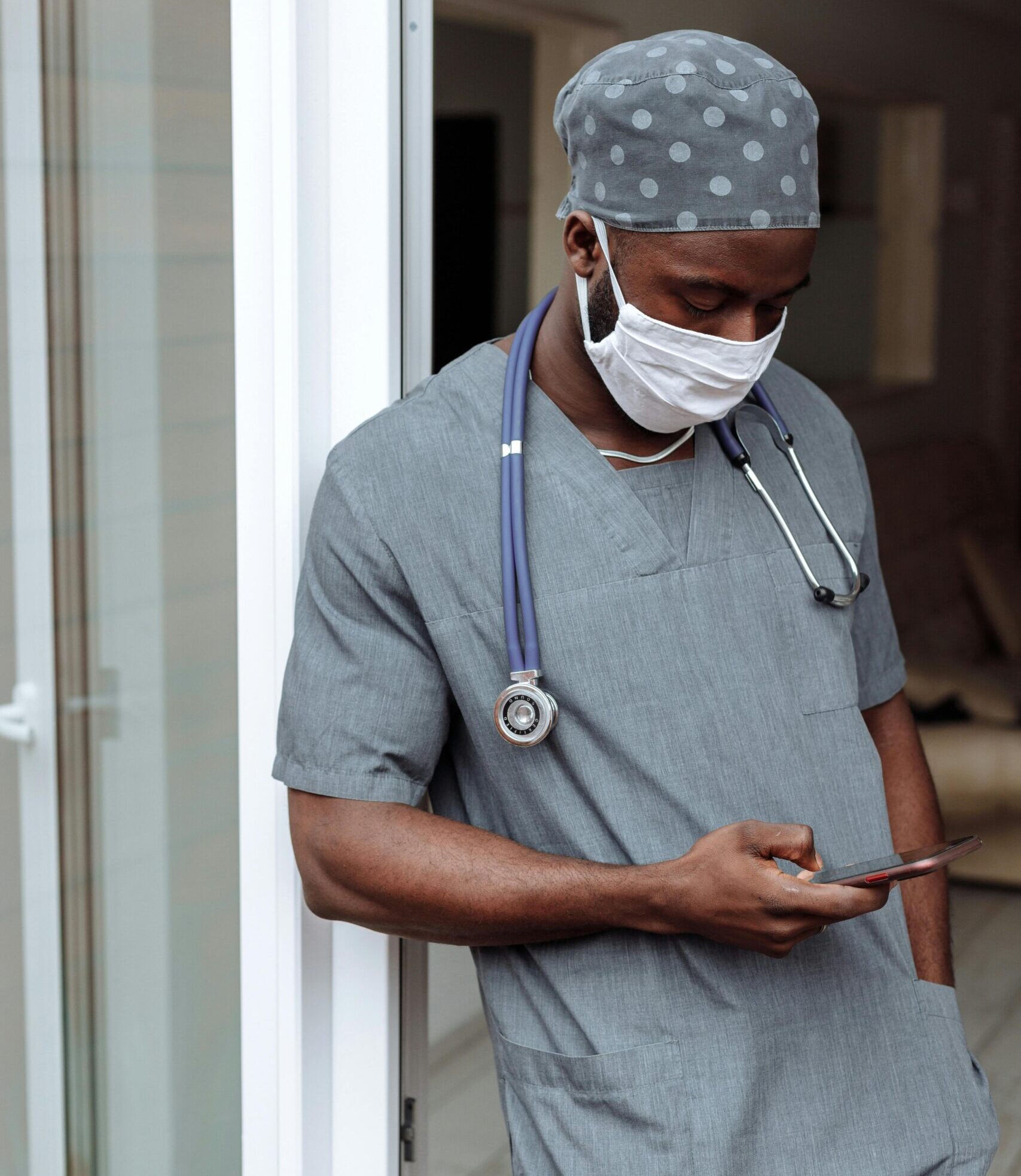 male doctor looking at his phone