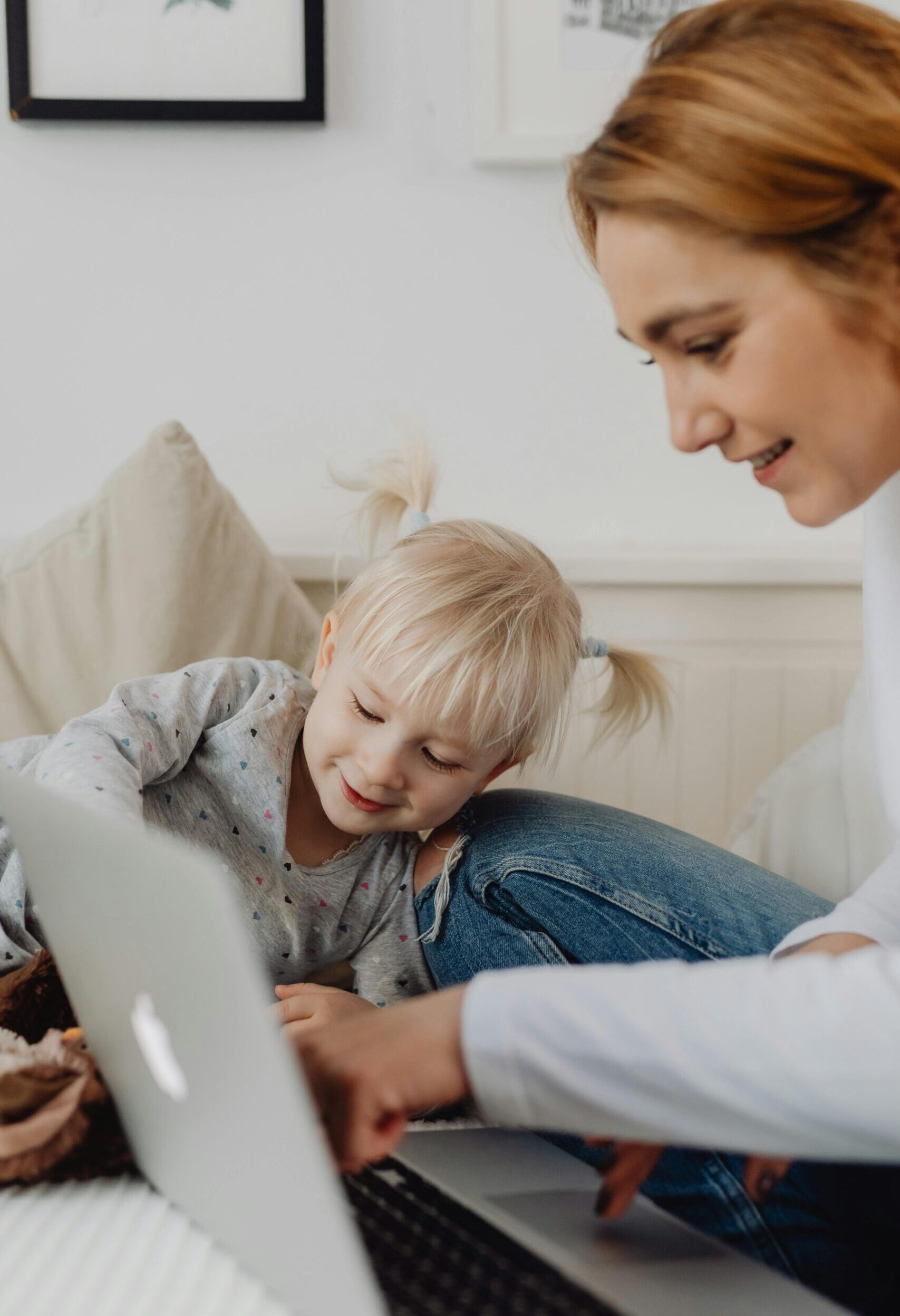 mother and daughter looking at laptop